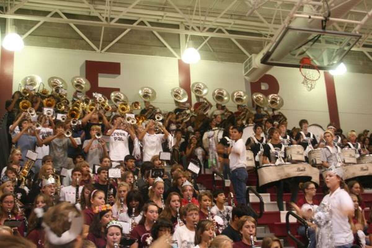 The band incites the pep rally crowd to stand and deliver.