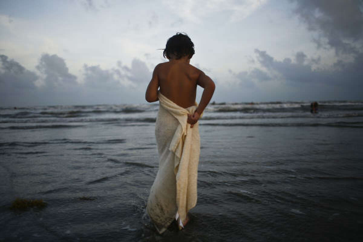 Back on the beach: Bryan Crooks, 4, wraps himself in a towel after a long day of swimming at West Beach.