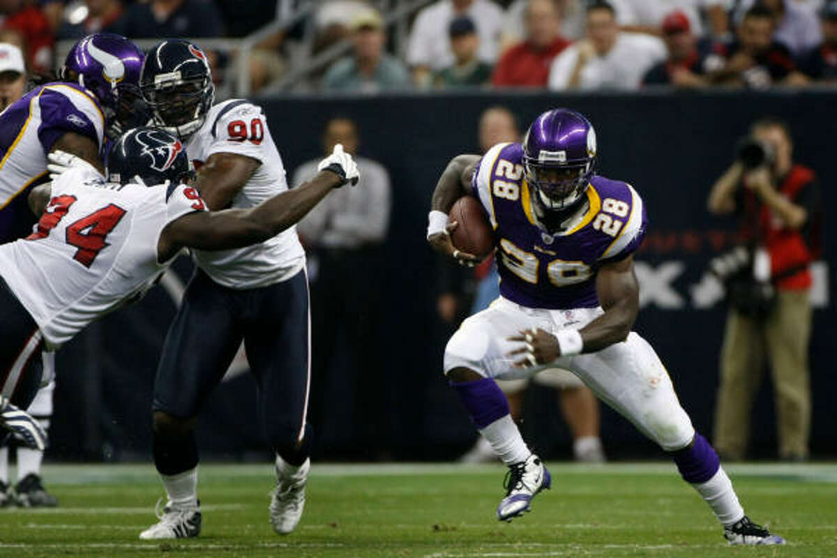 Vikings RB Adrian Peterson runs through the Texans defense on his way to score a touchdown in the first play from scrimmage.