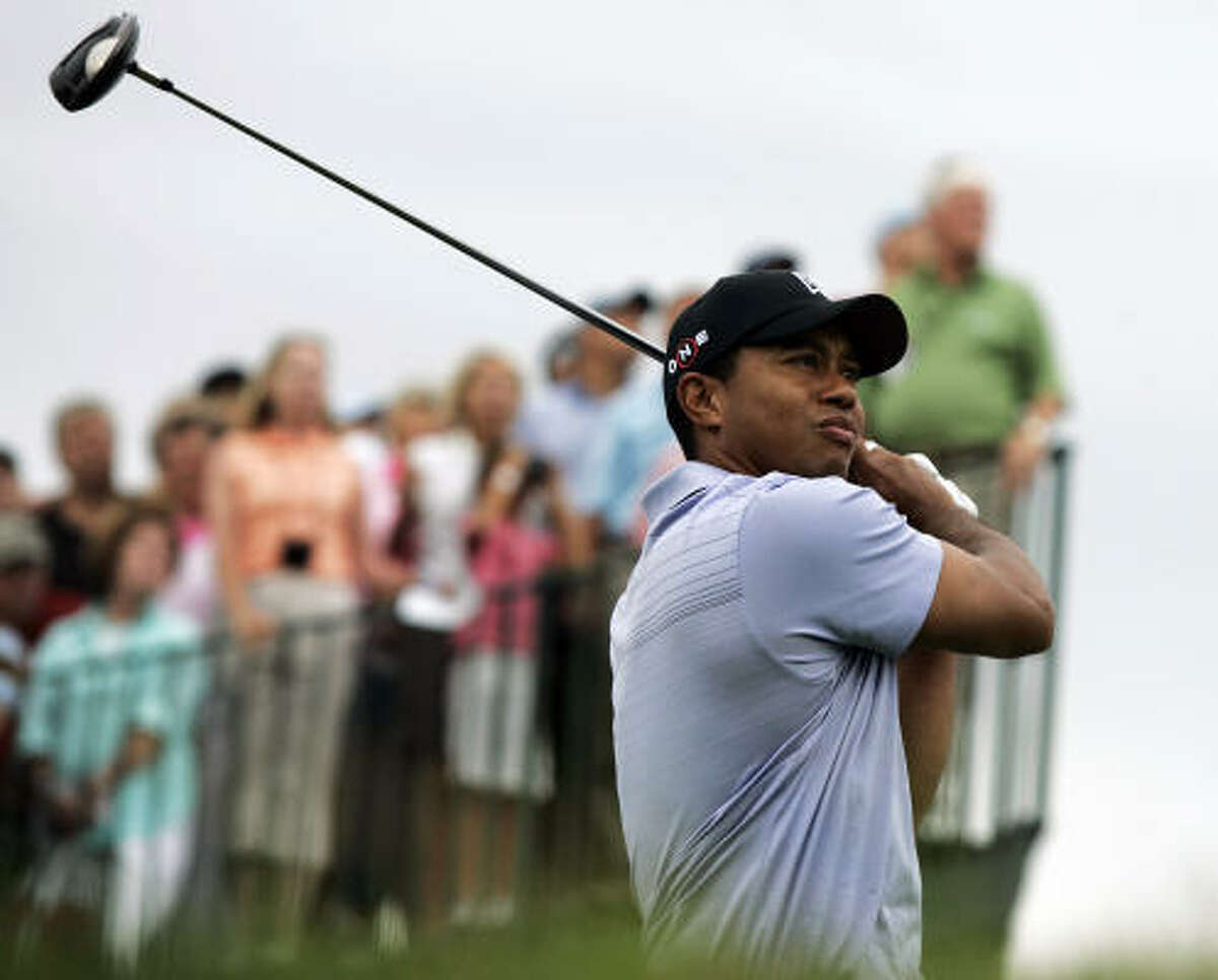 Tiger Woods watches his shot on the 15th hole during the first round of The Barclays golf tournament Thursday in Jersey City, N.J. Woods shot a 1-under 70 in the first round.