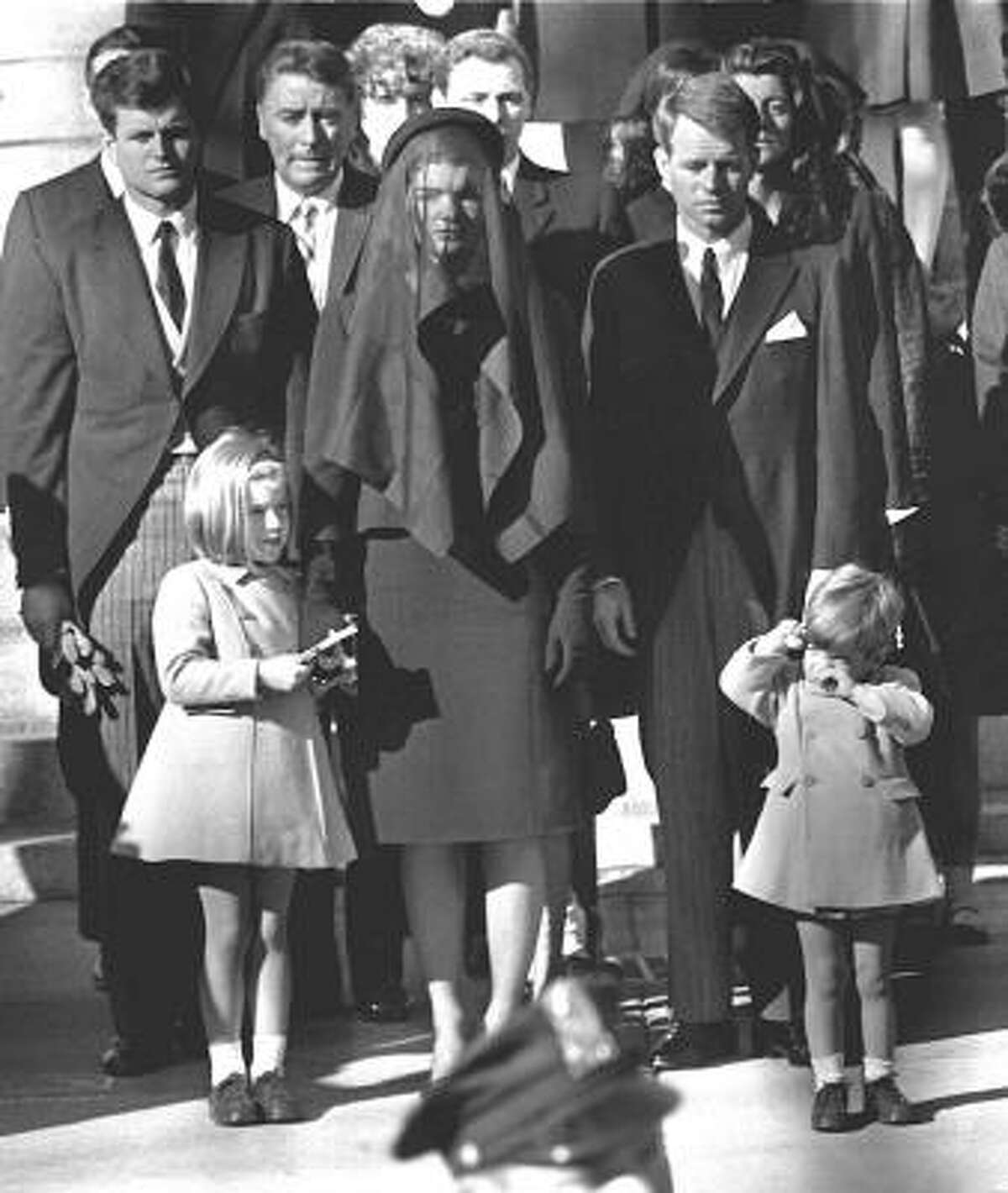 This November 26, 1963 file photo shows Jaqueline Kennedy, her children Caroline Kennedy and John F. Kennedy Jr, brothers-in law Ted Kennedy, left rear, and Robert Kennedy, right, during the funeral for her husband U.S. President John F. Kennedy in Washington, DC.