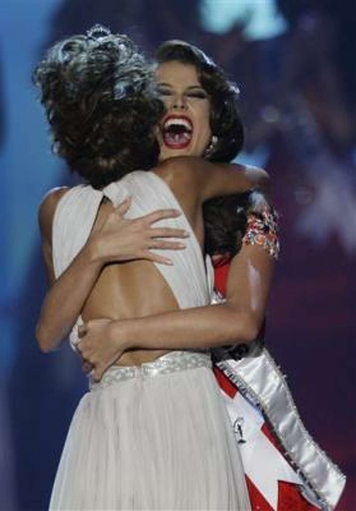 Miss Venezuela Stefania Fernandez, left, reacts as Miss Universe 2008 Dayana Mendoza, also of Venezuela, places the Miss Universe 2009 sash on her at the end of the Miss Universe beauty pageant in Nassau, Bahamas, Sunday, Aug. 23, 2009.