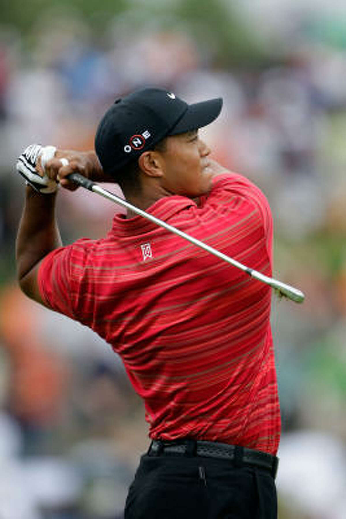 Tiger Woods hits a shot on the practice ground before the final round.