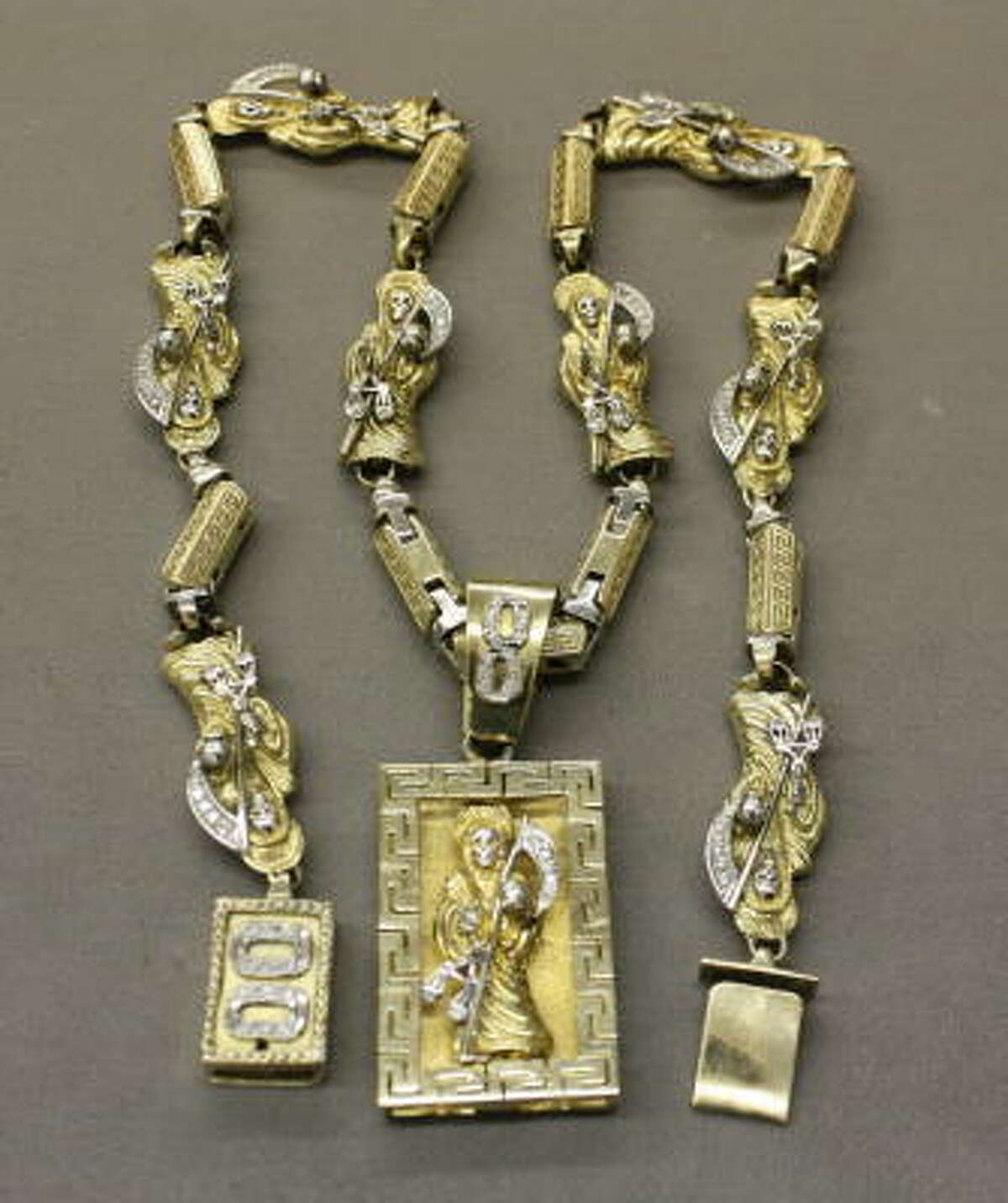 Jewelry and other lavish items seized from criminals are hitting the auction block. Among them is a diamond and gold Santa Muerte necklace (full story).