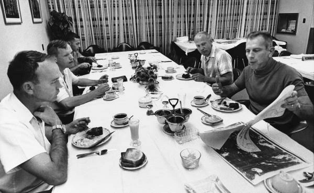 Apollo astronauts listen to Deke Slayton, director of flight crew operations for historic Apollo 11 flight, right, as they have their pre-flight breakfast at Cape Kennedy, Florida, on July 16, 1969. From left, they are Command Module pilot Michael Collins, Command Pilot Neil A. Armstrong, William A. Anders, and Edwin E. Aldrin Jr. Anders is a member of the Apollo 11 backup crew.