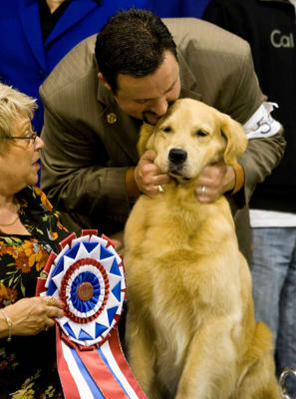 Dog show handler Clint Livingston shows his appreciation for a Golden Retriever named Champion of Toasty's Treasure Island who won the Reliant Park World Series of Dog Shows' Best in Show. Livingston is from Brighton, Colorado and "Treasure" is owned by Pam and Jerry Oxemburge who live in Boca Raton, Florida.