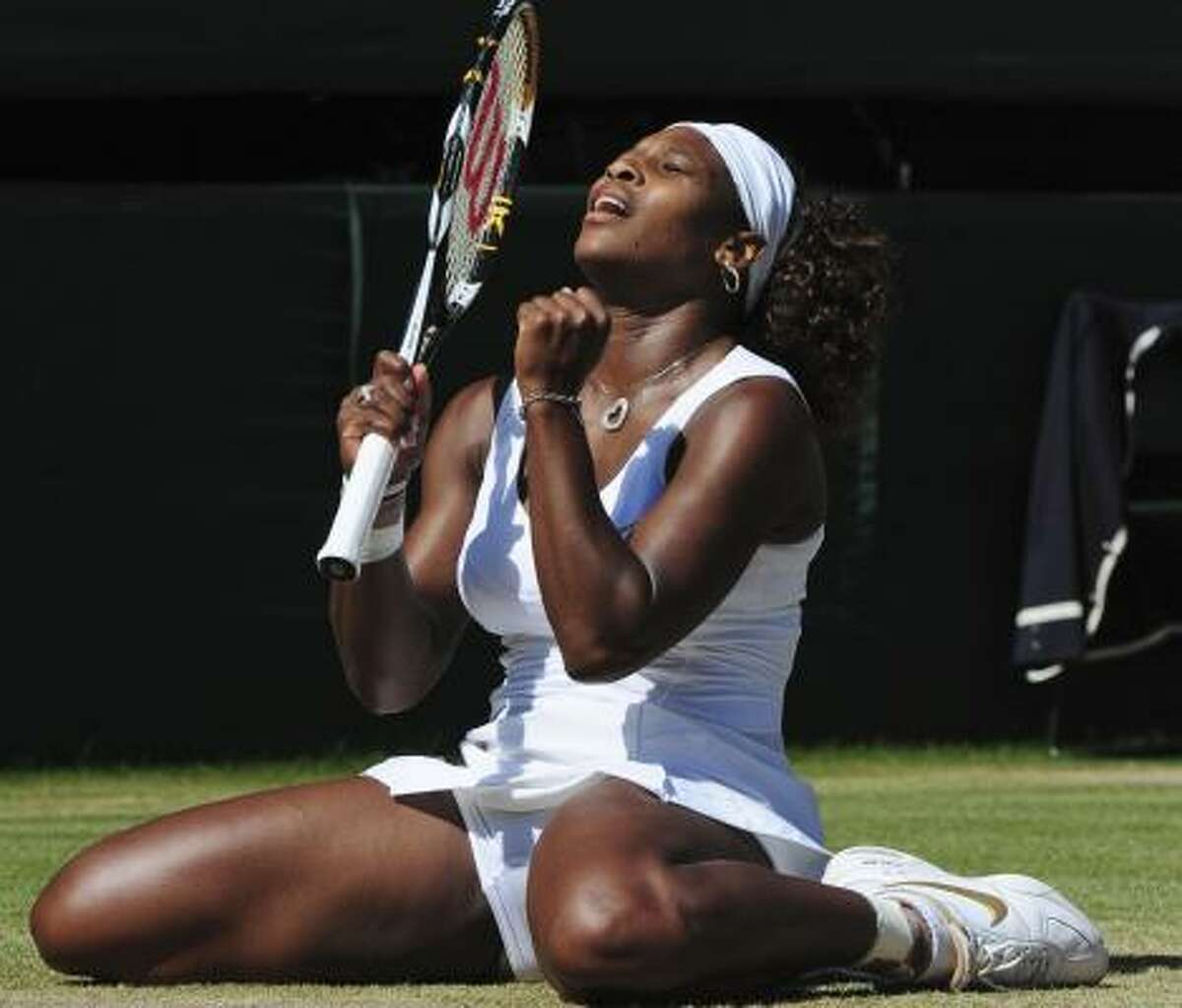Serena Williams celebrates match point against sister Venus. Serena won 7-6 (3), 6-2 for her third Wimbledon title and 11th Grand Slam championship.