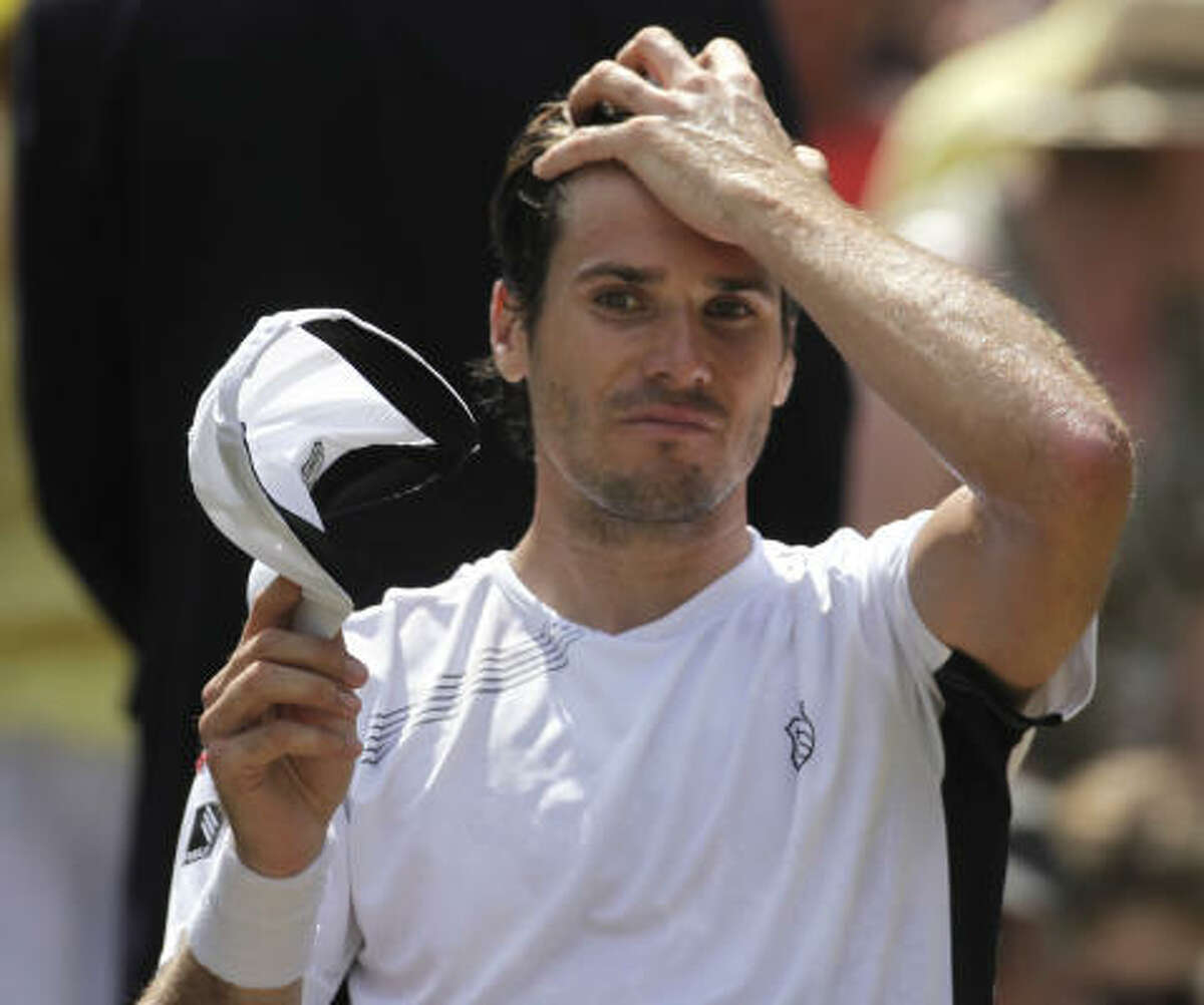 Tommy Haas, of Germany reacts during a break in play with Roger Federer.