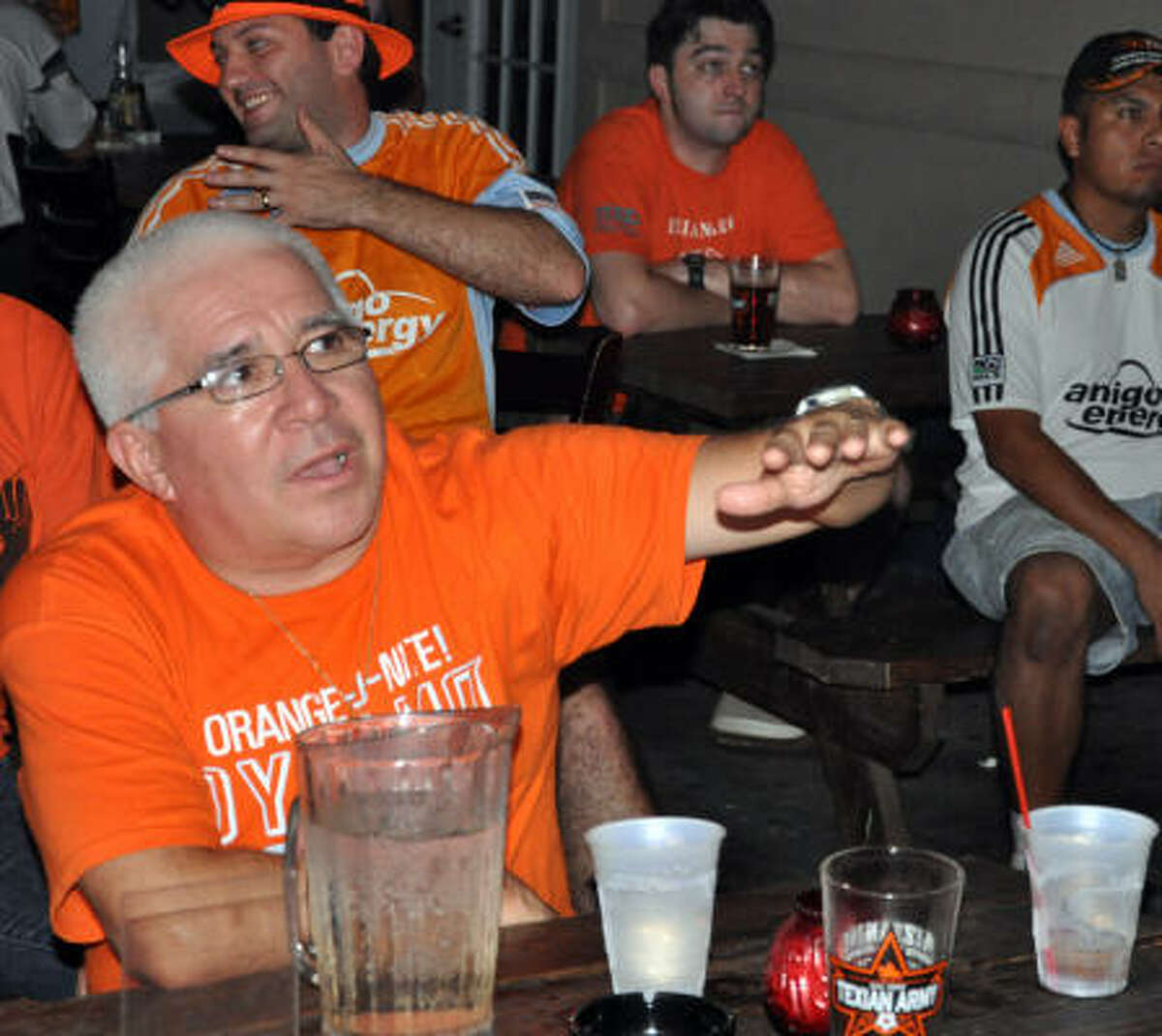 Donald Buckholt discusses the game with friend Andy Jackson. Members of the Texian Army gather at the Mezzanine Lounge to watch the away game.
