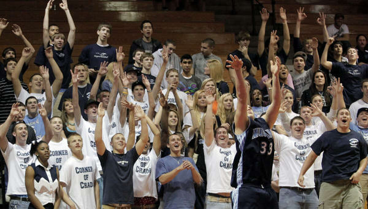 The Kingwood Corner of Chaos cheers on senior Mike Mullin as he puts up a 3-pointer,