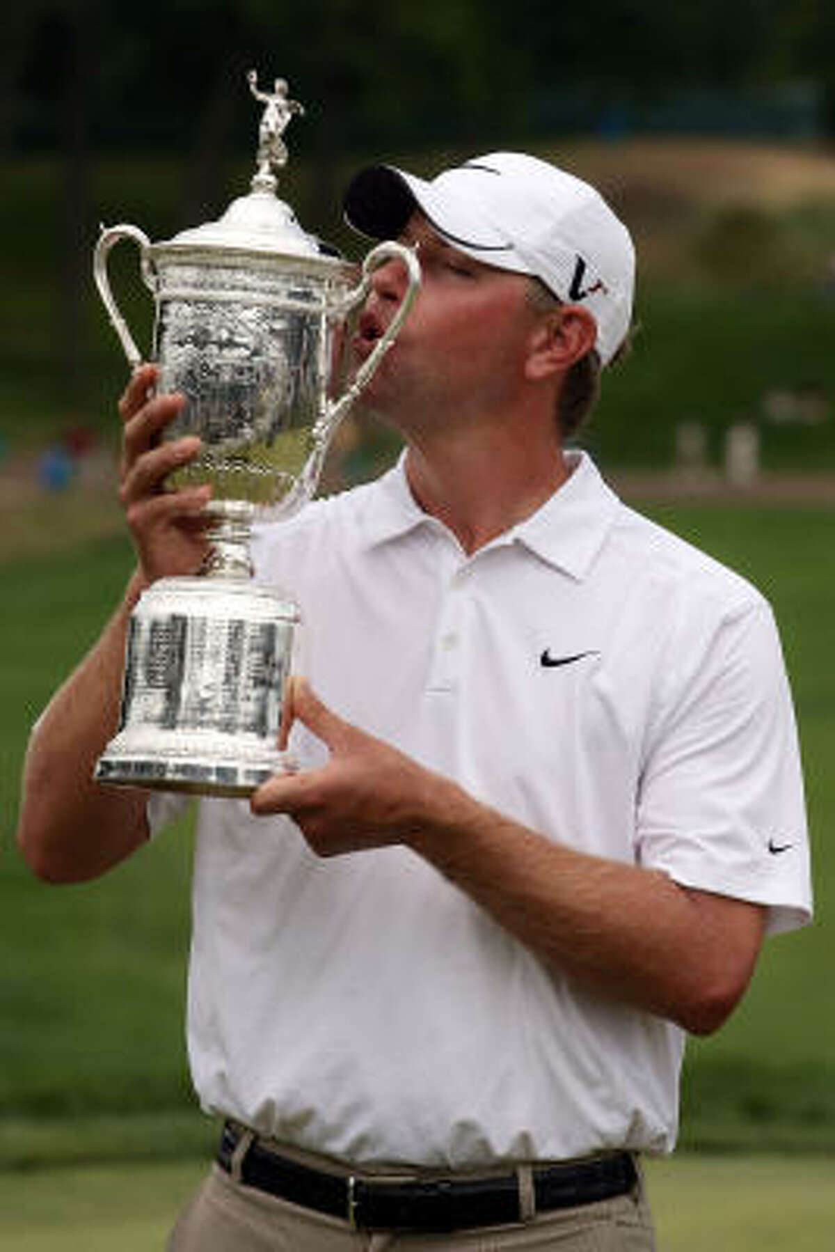 Lucas Glover celebrates with the winner's trophy after his two-stroke victory at the 109th U.S. Open.