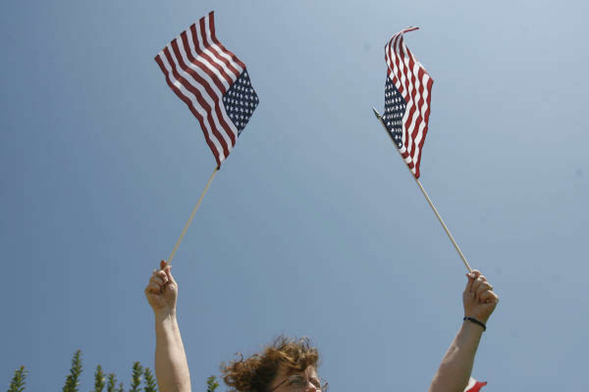 Sandy Allen, a teacher in Baytown, participates in a San Jacinto Tea Party Flag Day rally. The holiday celebrates the adopting of the flag in the United States 232 years ago.