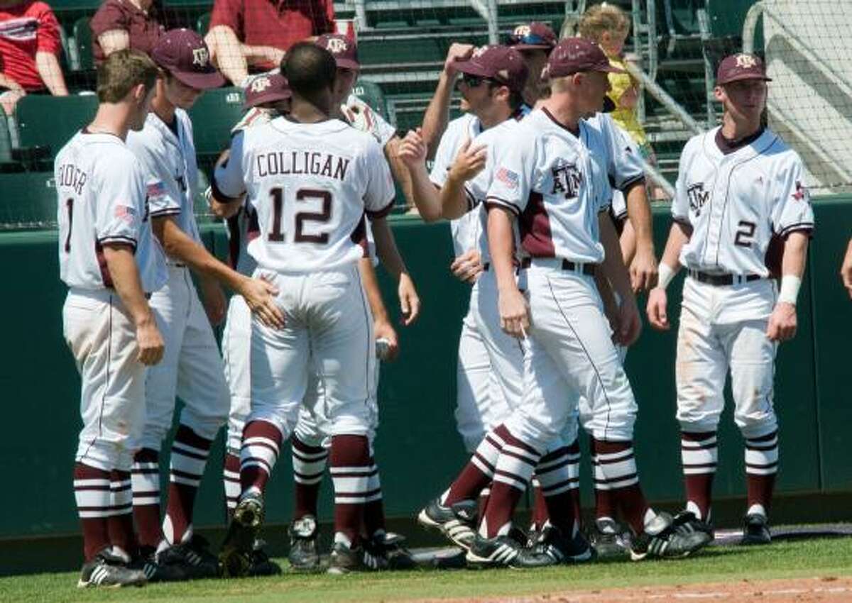 May 29: Oregon State 9, Texas A&M 8 Texas A&M's Kyle Colligan is congratulated by teammates after hitting a solo home run in the fourth inning.