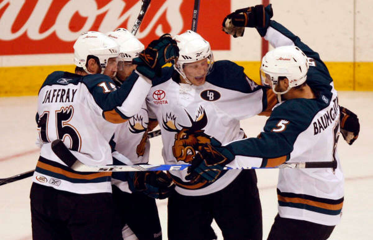 The Manitoba Moose celebrate a goal.