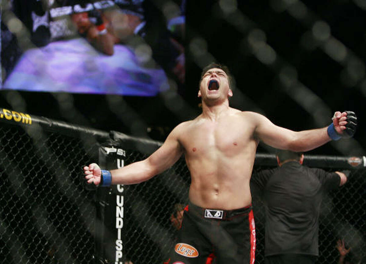 Lyoto Machida celebrates his second round knockout victory over Rashad Evans during their UFC light heavyweight title fight.