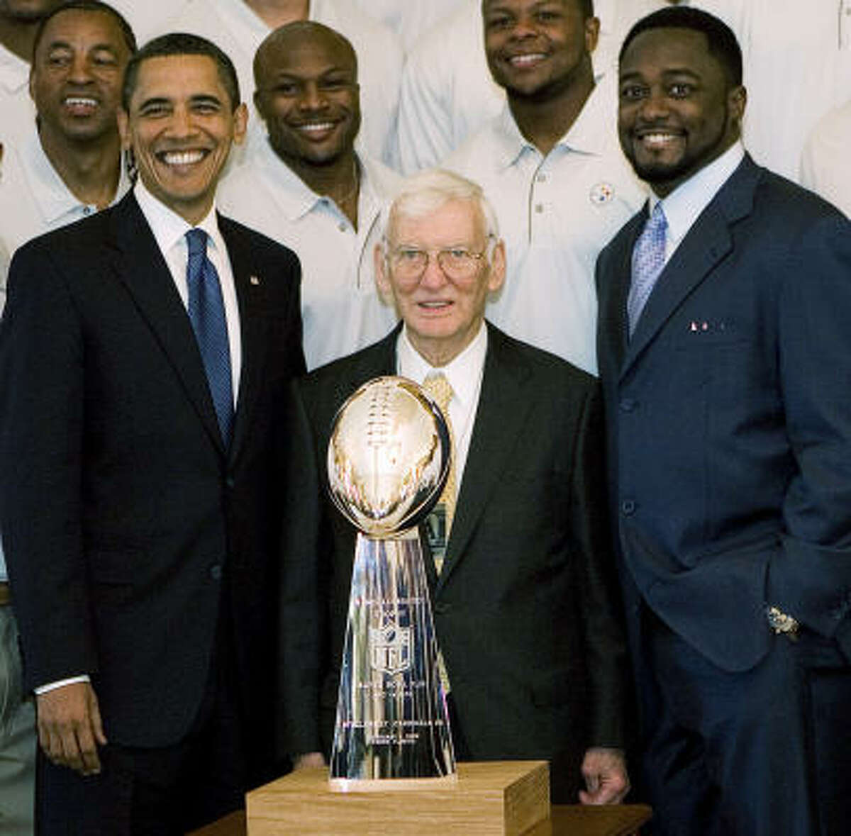 President Barack Obama poses with Pittsburgh Steelers Chairman Dan Rooney and head coach Mike Tomlin in the East Room.