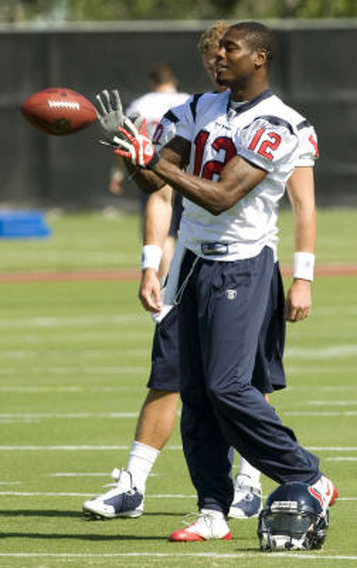 Texans wide receiver Jacoby Jones catches a football during warm-ups.