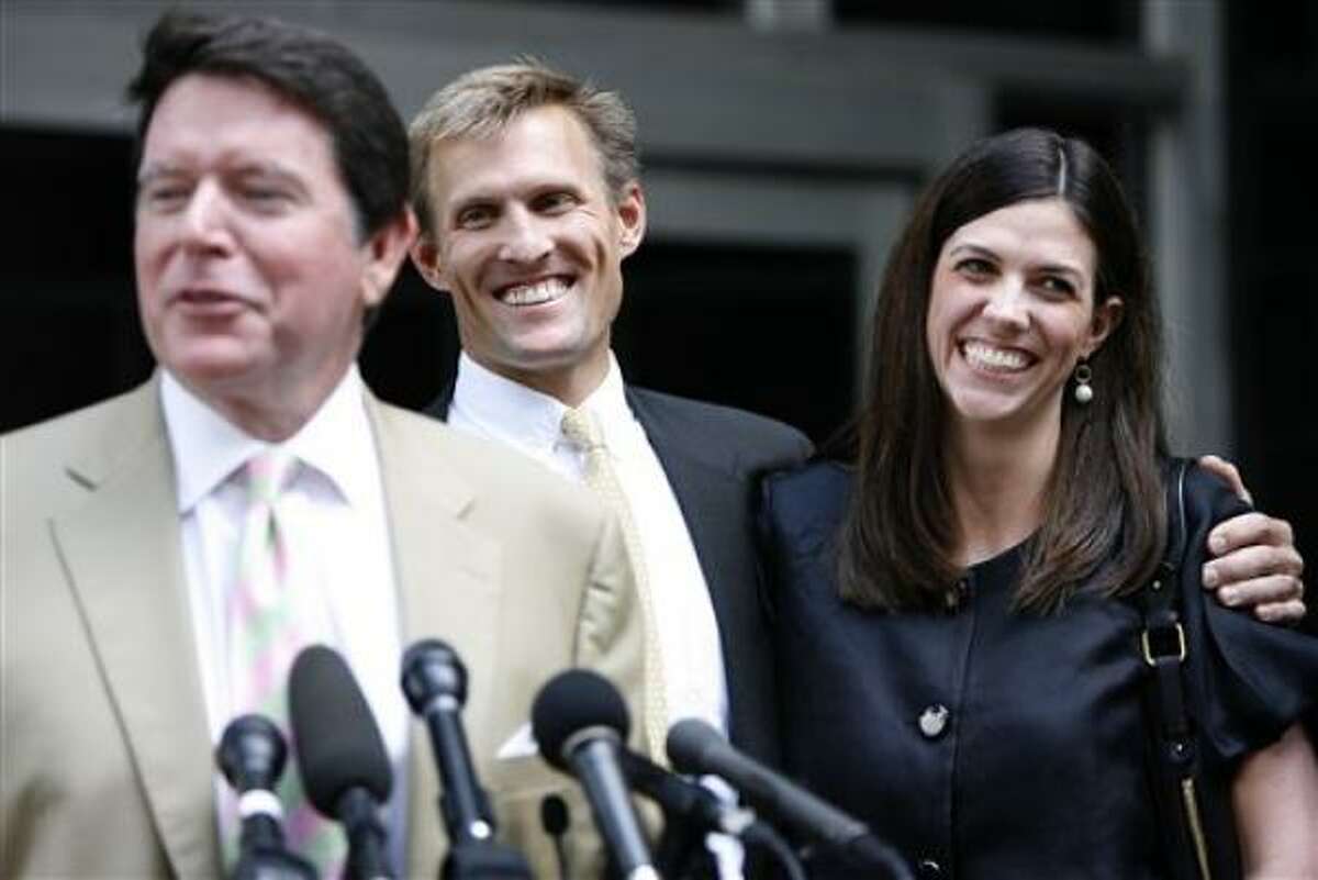 Laura Pendergest Holt, ejecutiva de Stanford Financial, sonríe junto a su esposo Jim Holt, mientras ambos escuchan a su abogado Dan Cogdell, frente a la Corte Federal, el jueves 14 de mayo del 2009
