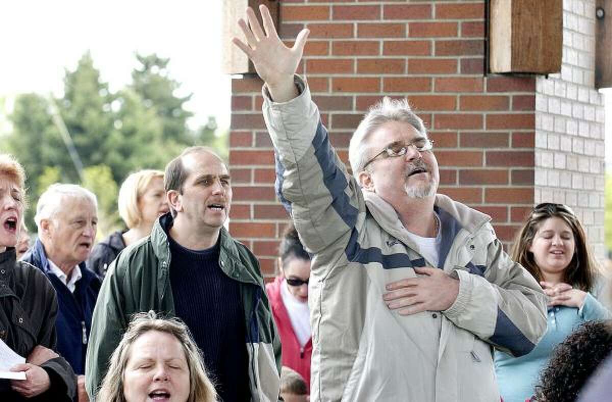 Tom Tilcock, of Salem, takes part in the National Day of Prayer event at the Riverfront Park Pavilion in Salem, Ore., on Thursday.