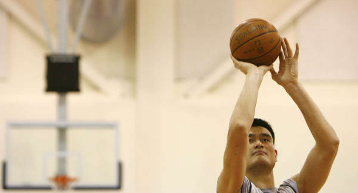 Rockets center Yao Ming works on free-throw shooting during practice in the Los Angeles Clippers training facility in Vista Playa.
