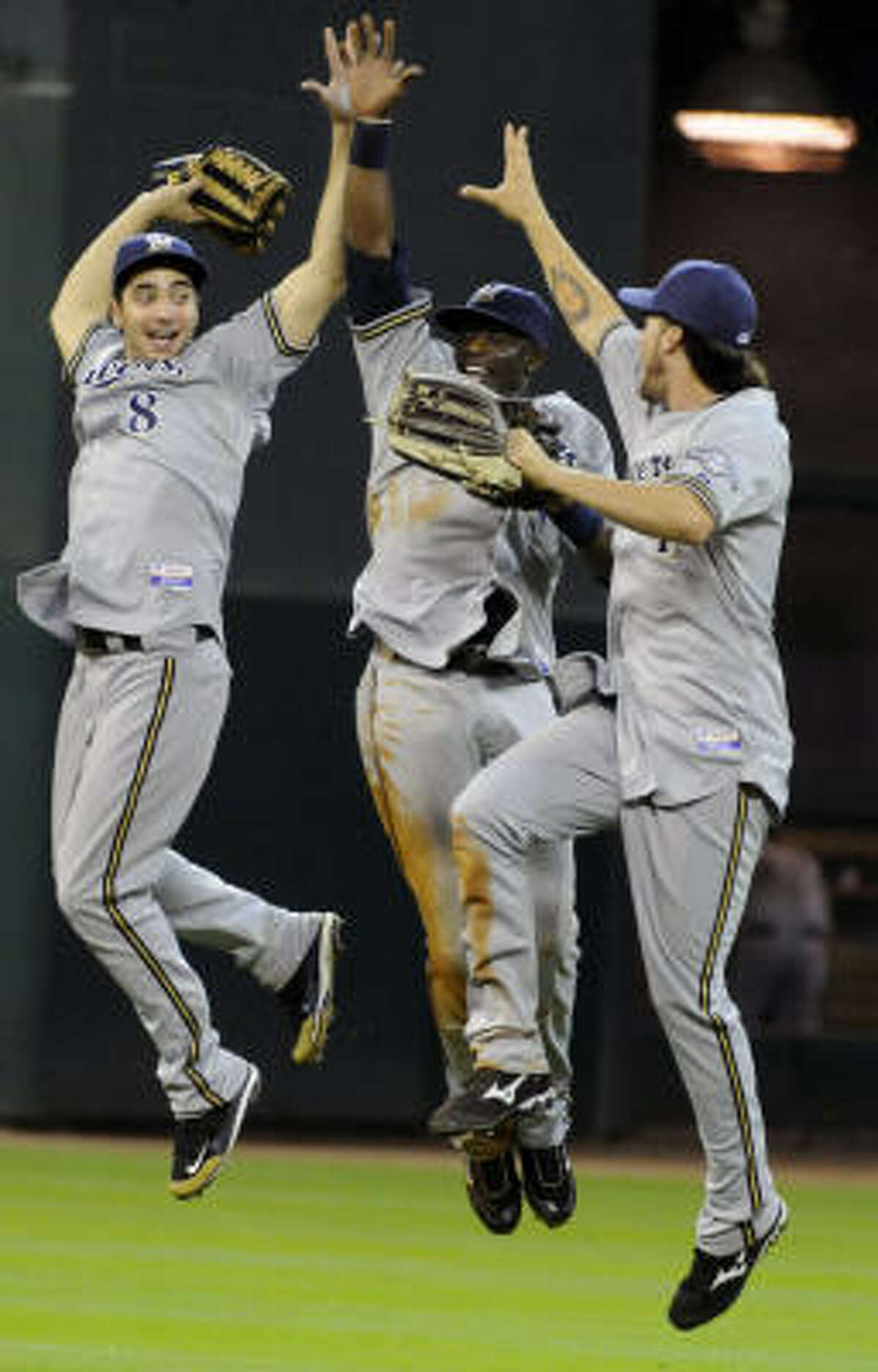 Milwaukee Brewers Ryan Braun (8), Mike Cameron (25) and Corey Hart celebrate their 9-8 win over the Houston Astros in 11th inning.