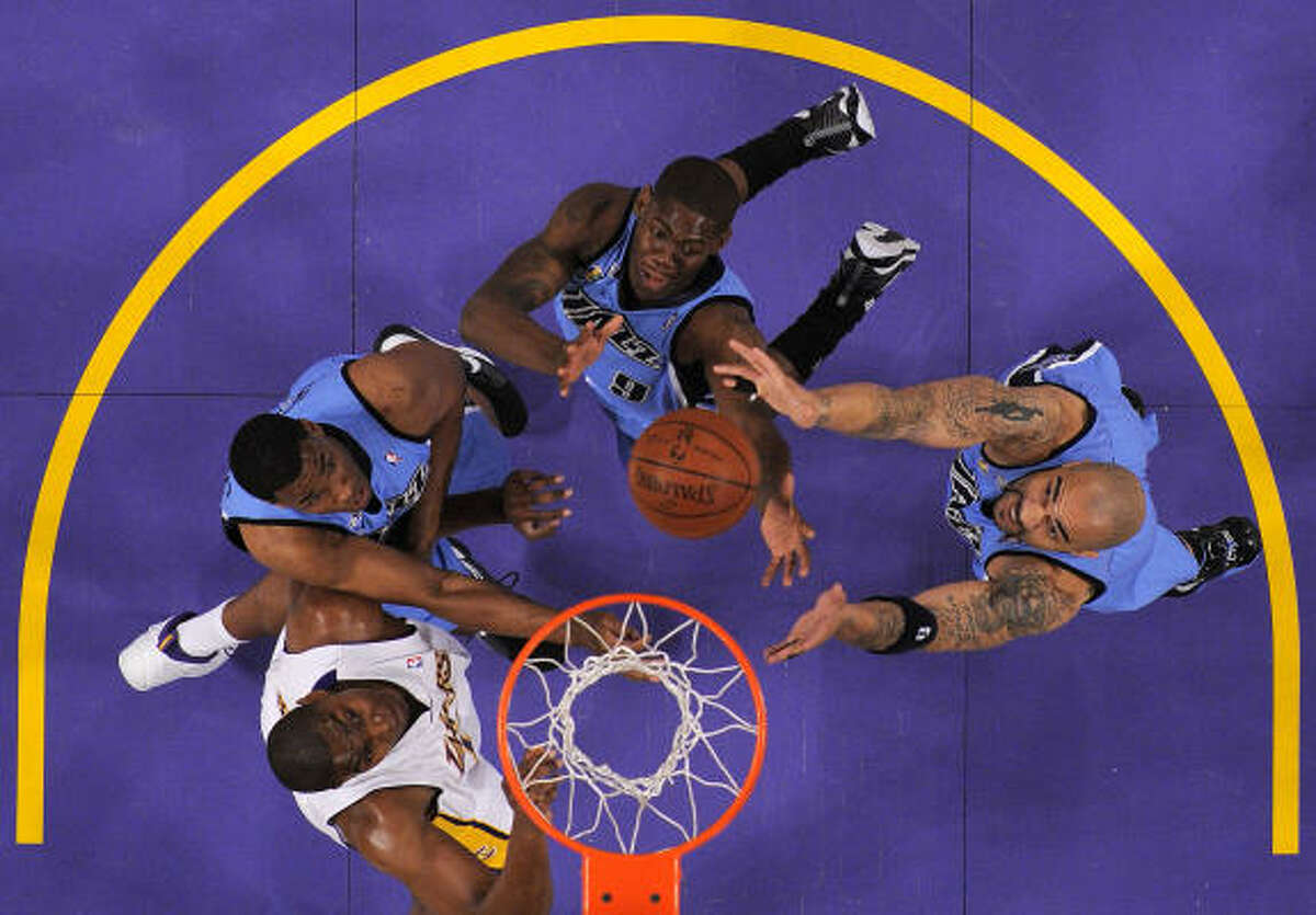 Game 1: Lakers 113, Jazz 110 Jazz forward Carlos Boozer grabs a rebound in front of teammates Ronnie Brewer, center, and Jarron Collins as they hold off Lakers forward Andrew Bynum.