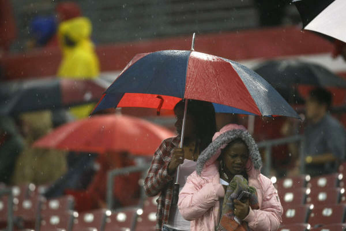 University of Houston football fans leaves the stands as the UH spring football game is called off because of lightning at Robertson Stadium.