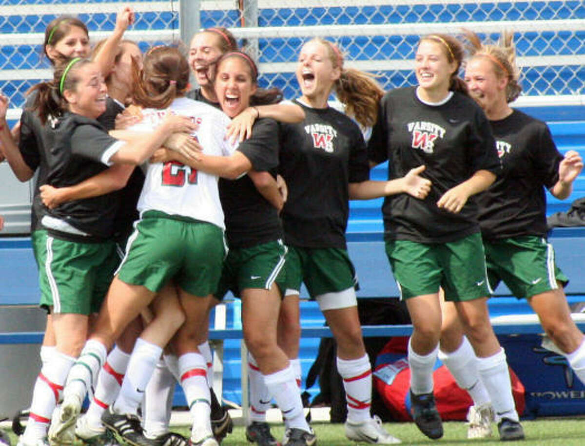 The Woodlands' Kylie Cook celebrates with teammates after she scored the first goal of the match Friday.