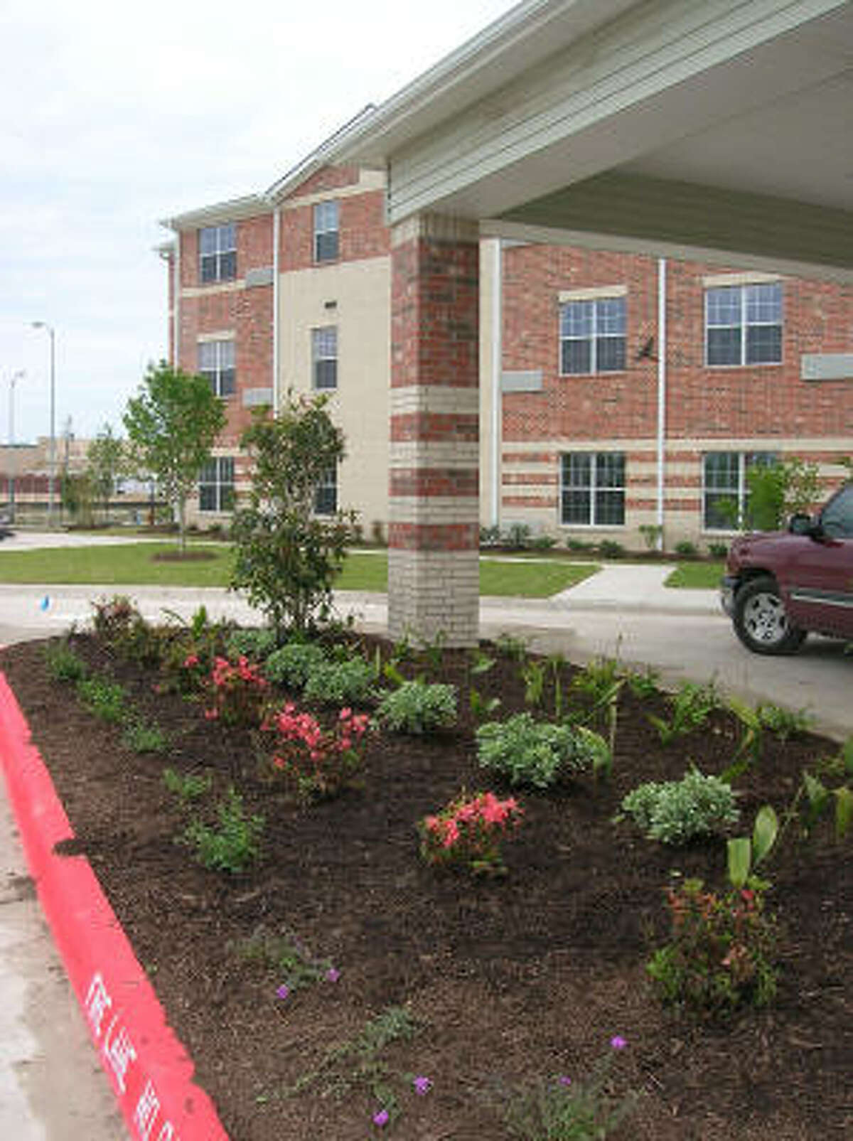 Fresh flowers and plants decorate the main entrance at the new-and-opening soon Bayou Glen Housing (an affordable senior housing community owned and operated by National Church Residences) at 11810 Southglen in the Alief area. Photo date 4-1-09.