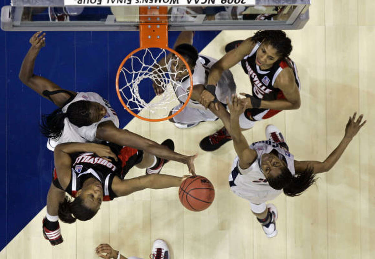 Louisville's Keshia Hines, bottom left, and Connecticut's Tina Charles top left, battle for a rebound.