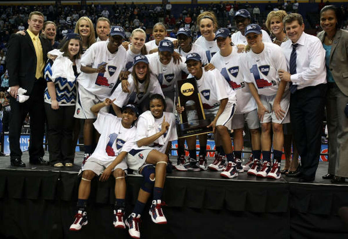 The Connecticut Huskies pose with the championship trophy during the NCAA Women's Final Four at the Scottrade Center in St. Louis.