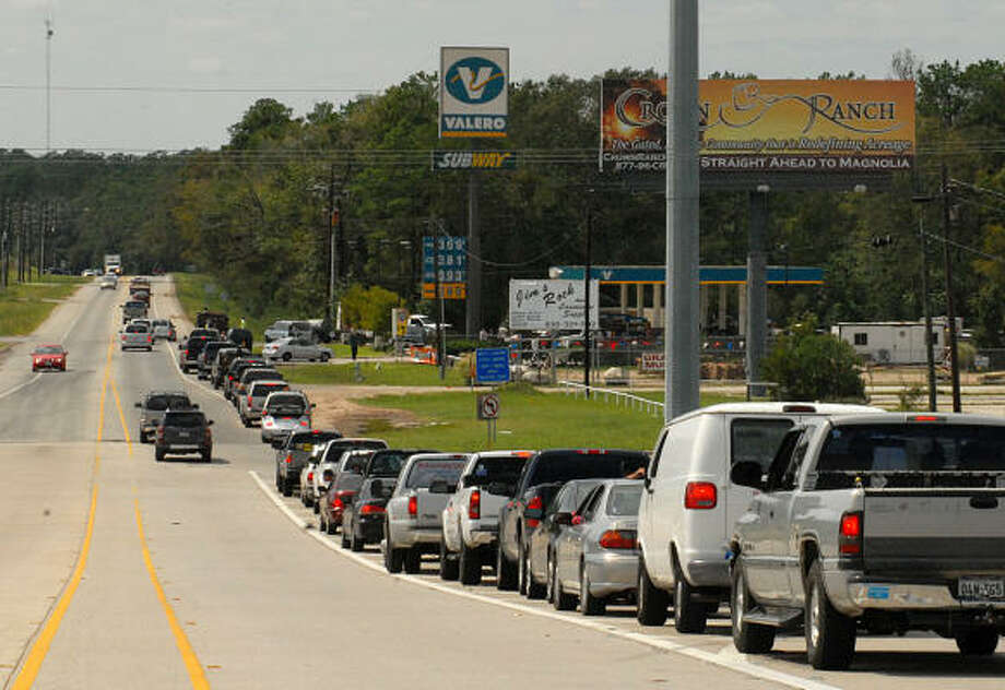Cars line up to get gas at the Valero station on FM 1488 and I-45 South. At times the line stretched over the I-45 bridge. Photo: David Hopper, For The Chronicle