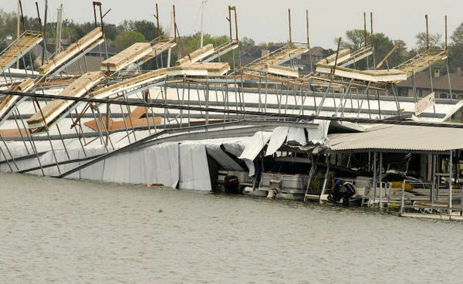 April Plaza Marina, 17742 105 West, on Lake Conroe, suffered significant damage when the wind caused a boat dock to flip up and on top of another boat dock at the marina. Photo: David Hopper, For The Chronicle