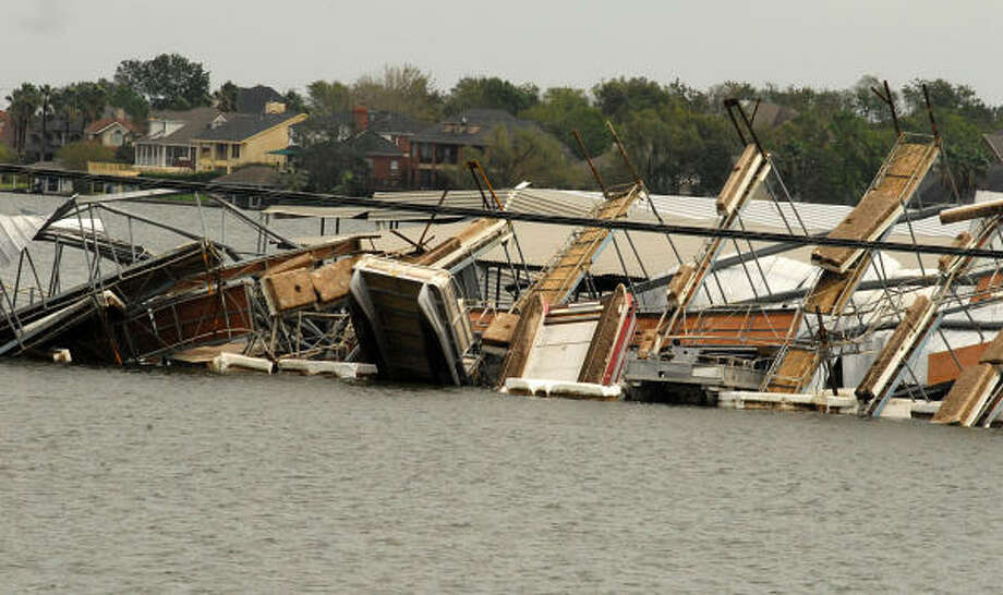 April Plaza Marina, 17742 Hwy 105 West on Lake Conroe, was hard hit by Hurricane Ike. Part of a boat dock was turned upside down and landed on another boat dock. Photo: David Hopper, For The Chronicle