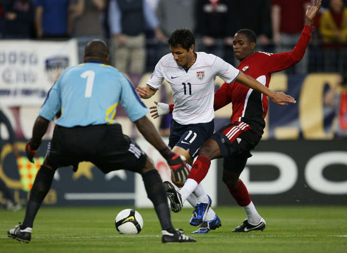 U.S. 3, Trinidad and Tobago 0 Brian Ching of the United States moves towards goalkeeper Clayton Ince as Aklie Edwards defends at LP Field in Nashville, Tenn.