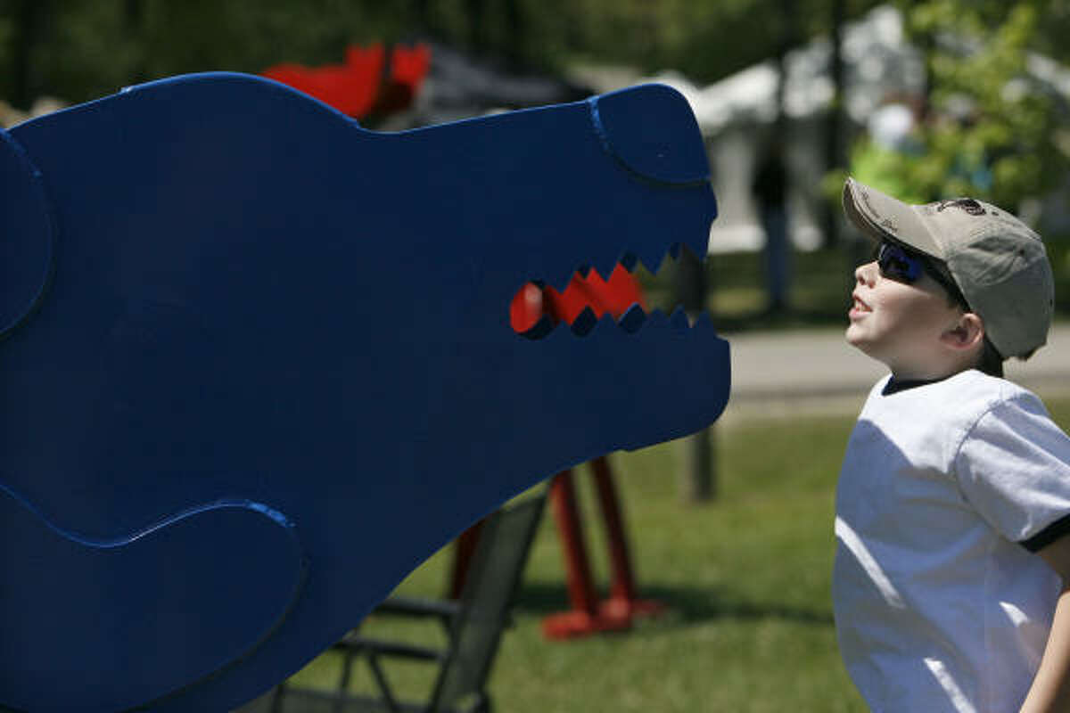 Logan Conchola, 7, of Houston, gets a close look at a sculpture of a bear created by Fred Prescott from Santa Fe, N.M. at the 12th Annual Bayou City Art Festival at Memorial Park.
