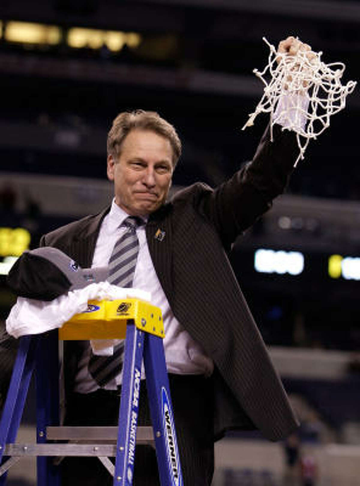 Midwest Region: Michigan State 64, Louisville 52 Michigan State coach Tom Izzo celebrates after cutting down the net following their 64-52 win against Louisville.