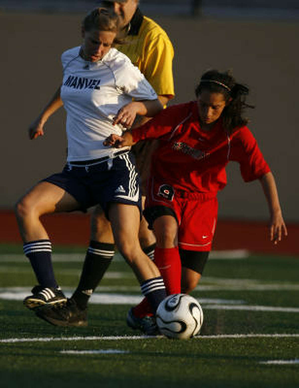 GOOSE CREEK MEMORIAL 2, MANVEL 0: Goose Creek Memorial's Brittany Garza, right, and Manvel's Tori Moore fight for control of the ball in Class 4A playoffs on March 20.