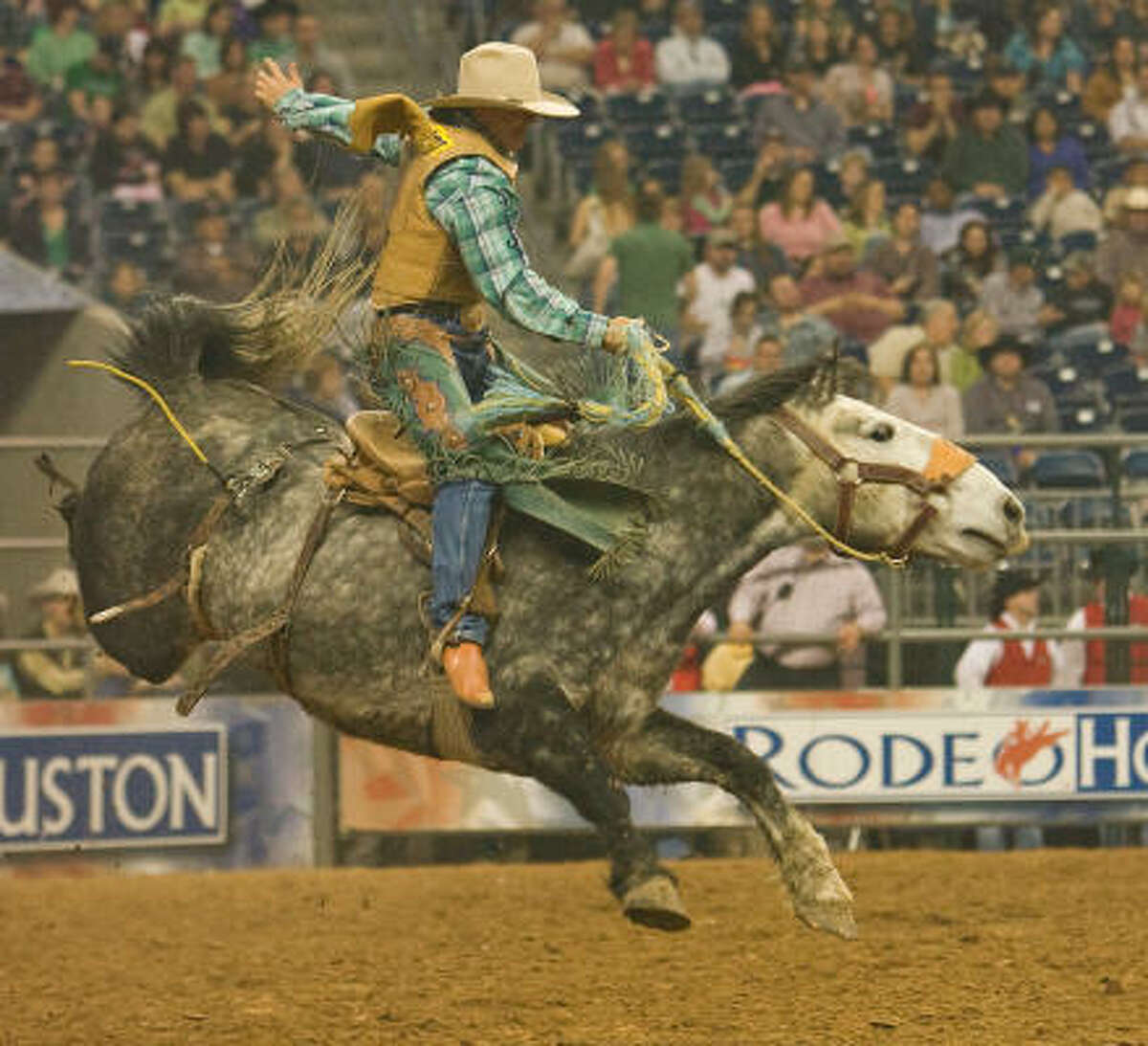 Dustin Flundra rides "Current Affair" in the saddle bronc event at the Houston Livestock Show and Rodeo.