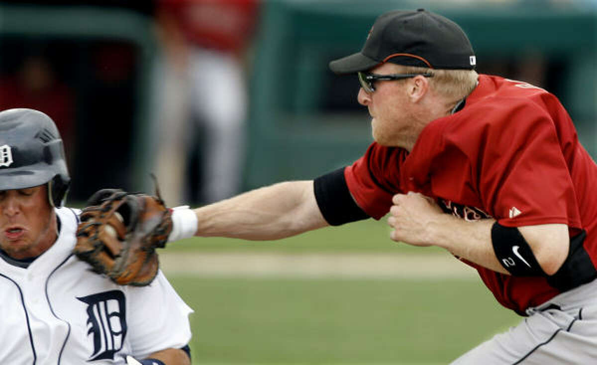 Astros first baseman Darin Erstad, right, hauls in a long throw from Miguel Tejada and tags out Brent Cleven.
