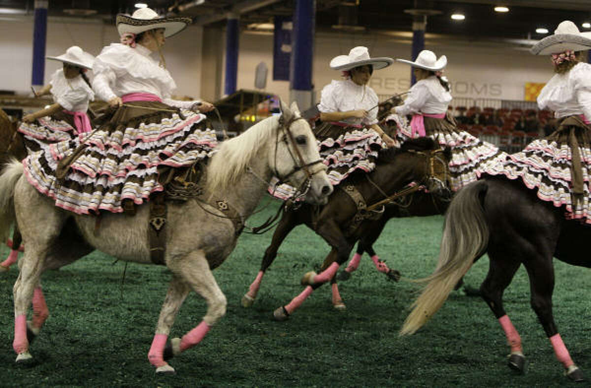 Las Christares, a female sidesaddle horse drill team from Houston, practice for their next performance at the Fiesta Charra in Reliant Center on Go Tejano Day at the Houston Livestock Show and Rodeo on Sunday, March 15, 2009, in Houston.