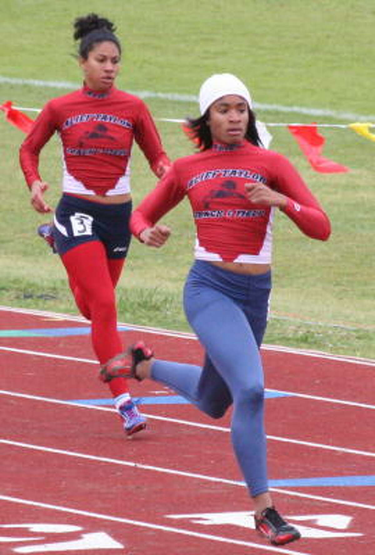 Alief Taylor's Morgan Presley (right) and Whitney Grant take the 400 meters 1-2.