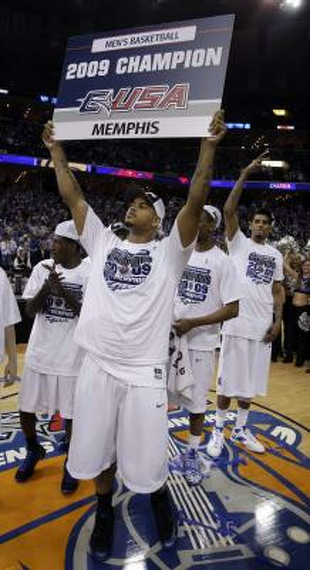 Championship game: Memphis forward Pierre Henderson-Niles holds up a sign for fans after the Tigers clinched their fourth straight C-USA tournament title with a 64-39 win over Tulsa.