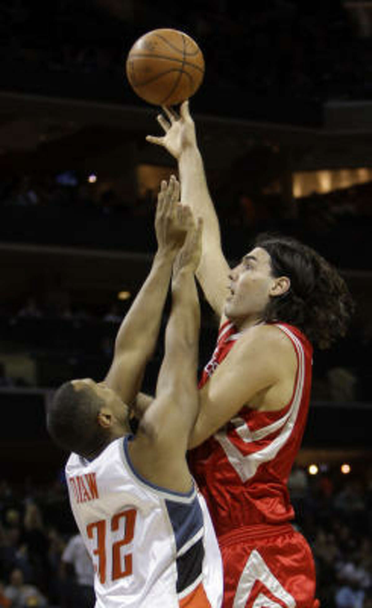 Luis Scola, right, shoots over Bobcats forward Boris Diaw in the second half. Scola had 15 points and six rebounds.