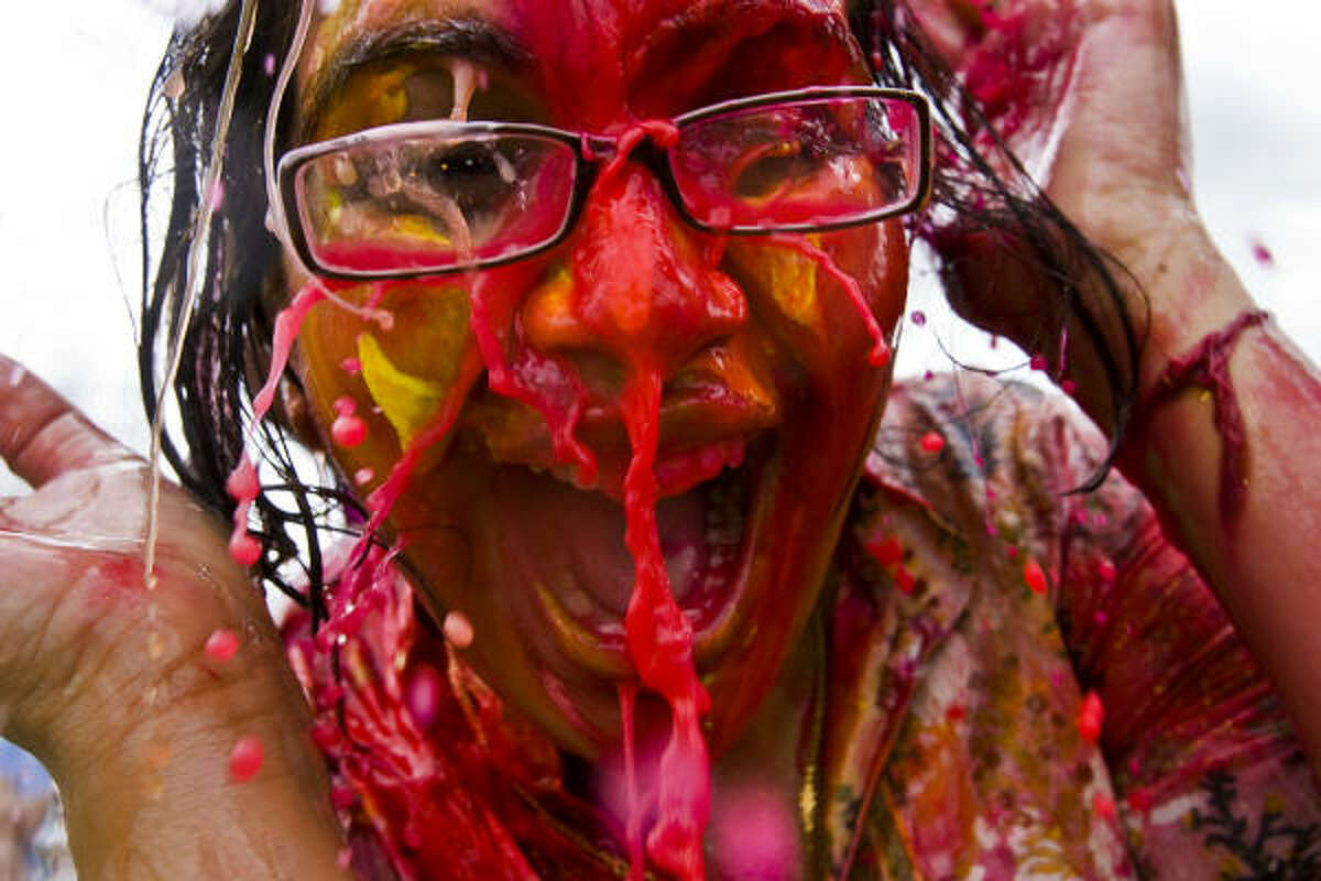 Kavita Jaiswal is doused with colored water during the Holi Celebration, or Festival of Colors, at Oyster Creek Park in Sugar Land.