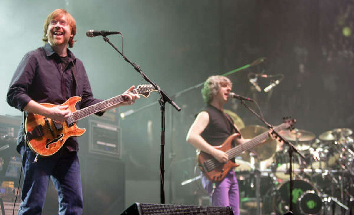 Phish guitarist Trey Anastasio, left bassist Mike Gordon, center; and drummer Jon Fishman perform in the opener of a three-night set in Hampton, Va.