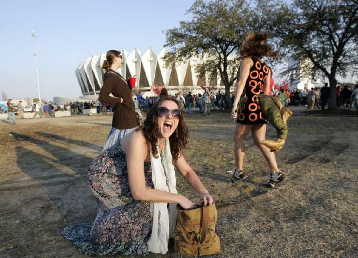 Phish fans Tracy Raasch, center, and Melissa Genrich dance before the show. Tickets went for up to $1,000 on the resale market.