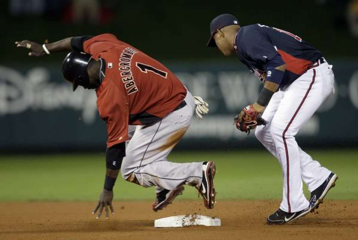Astros outfielder Reggie Abercrombie (1) safely steals second base while Atlanta Braves infielder Yunel Escobar, right, looks for the ball during the first inning.
