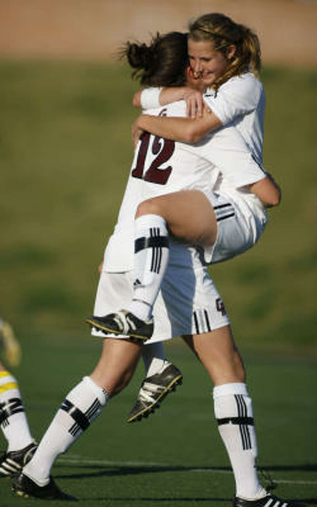 Cinco Ranch player Kayla Anderson, left, gets a celebratory hug from teammate Missy Wentz after Anderson's free kick from about 30 yards out gave the Cougars a 1-0 lead over Klein. The Cougars went on to win 2-0.