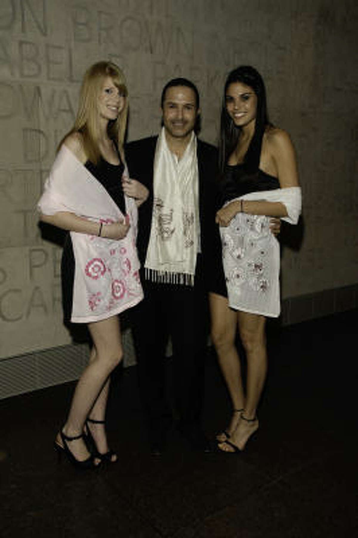 Matin poses with models wearing Afghan Hands scarves at the Museum of Fine Arts Houston.